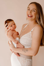 Load image into Gallery viewer, Model holding her baby laughing wearing Vienna nursing bra and Lemonie high waist in colour ivory
