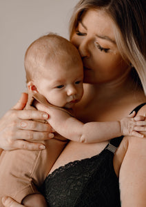 Mother holding her baby wearing Valeria nursing bra in colour black