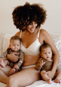 Model sitting on a sofa with her twins wearing Valeria nursing bra and Leia hipsters in colour ivory