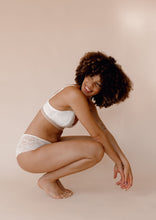 Load image into Gallery viewer, Model sitting wearing Valeria nursing bra and Leia hipster in ivory

