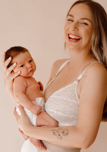 Model holding her baby wearing Vienna nursing bra and Lemonie high waist in ivory