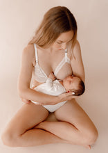Load image into Gallery viewer, Mother holding her sleeping baby wearing Vienna nursing bra and Lemonie high waist in colour ivory
