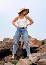 Load image into Gallery viewer, Model standing on a mountain wearing Viola nursing top with a pair of jeans
